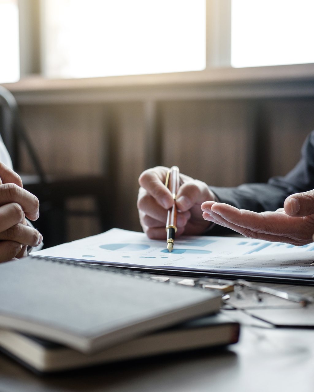 Two people working through documents together across a table